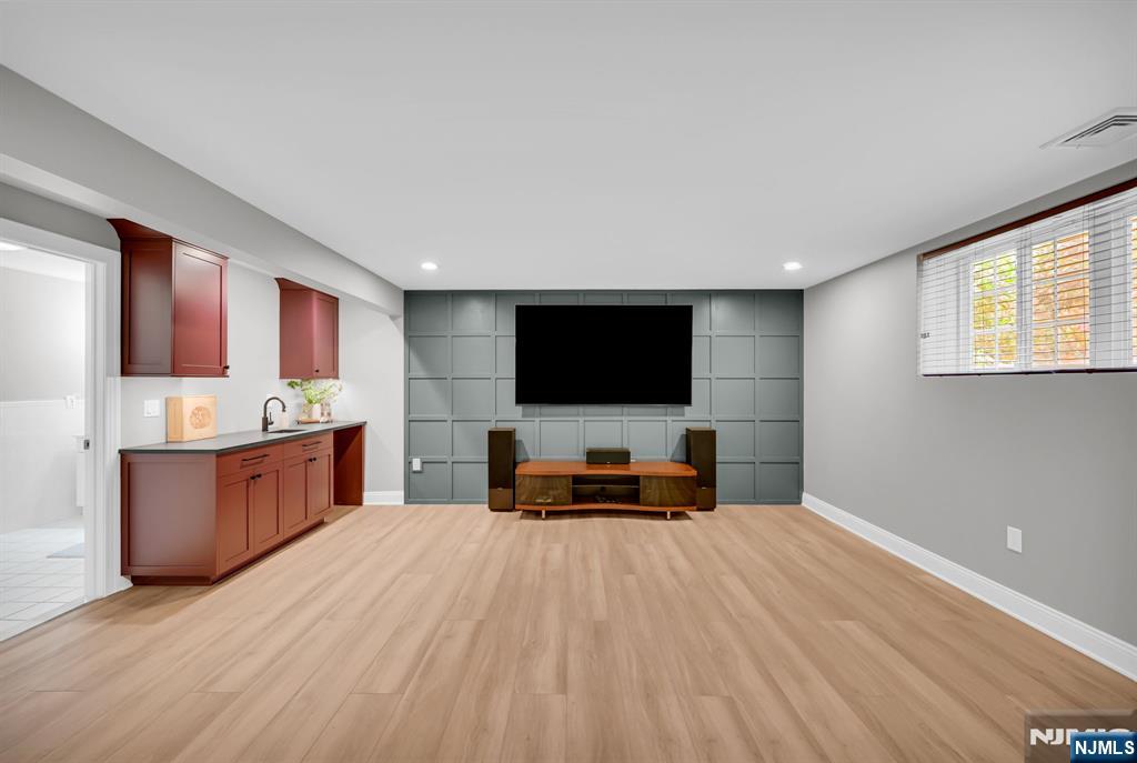 3 Brook Ridge Court Cedar Grove, NJ 07009 - Photo 39 of 49 a living room with a flat screen tv and a table