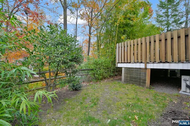 a view of a backyard with wooden fence