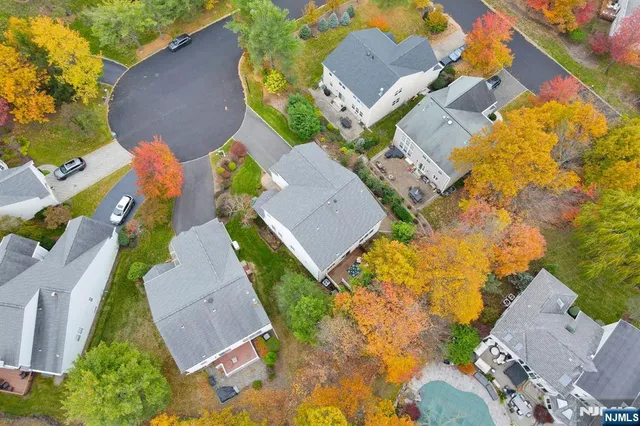 an aerial view of a house with a yard and trees