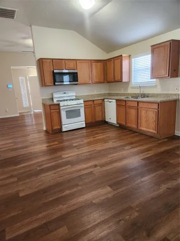 a kitchen with stainless steel appliances wooden cabinets and a counter top space