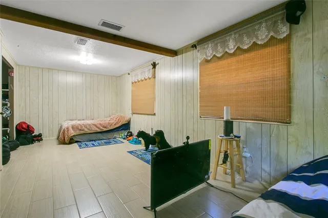 a spacious bedroom with a bed and a couch