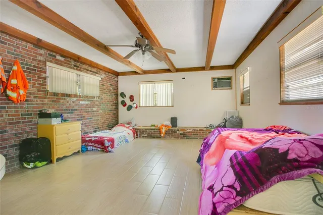 a bedroom with bed and a couch