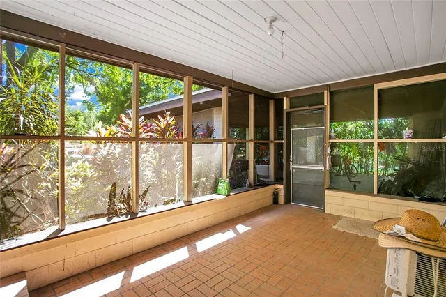 a view of a porch with furniture and garden