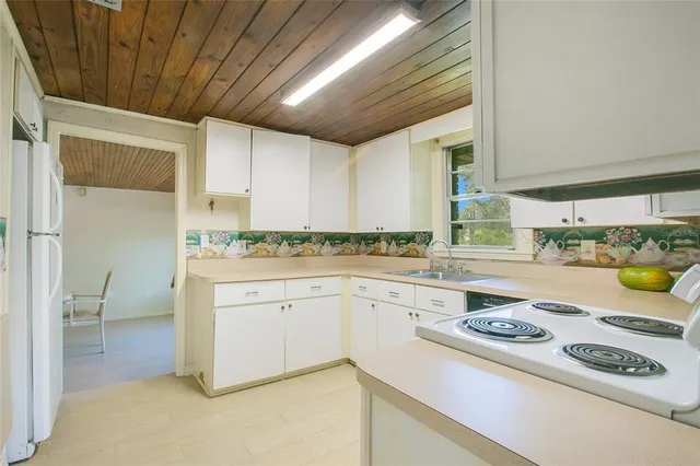 a kitchen with a stove a sink and a refrigerator