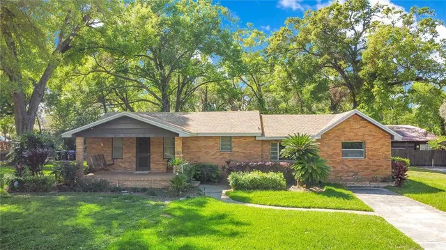 a front view of a house with a garden and plants