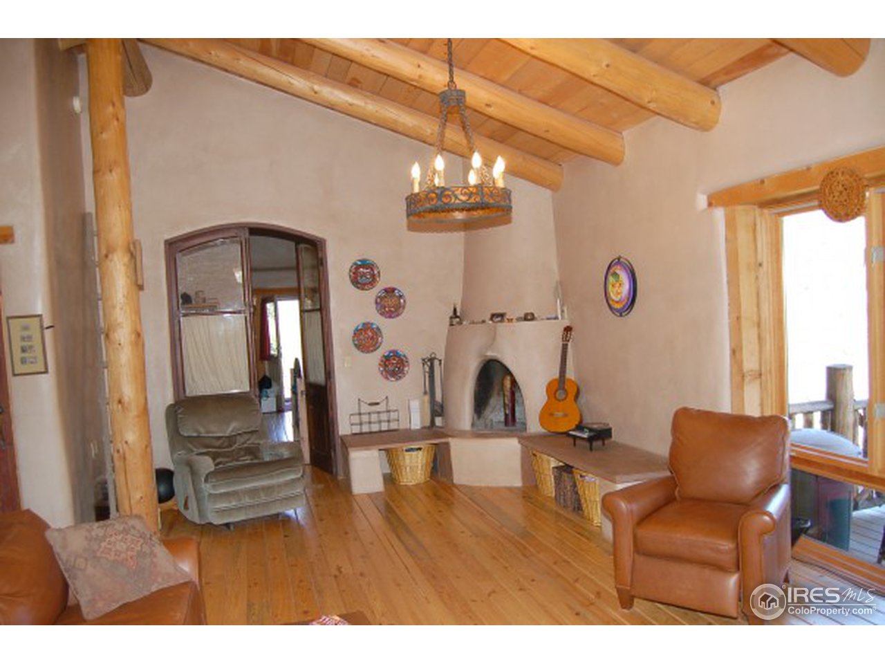 1016 Vision Way Lyons, CO 80540 - Photo 3 of 13 a living room with furniture and a chandelier
