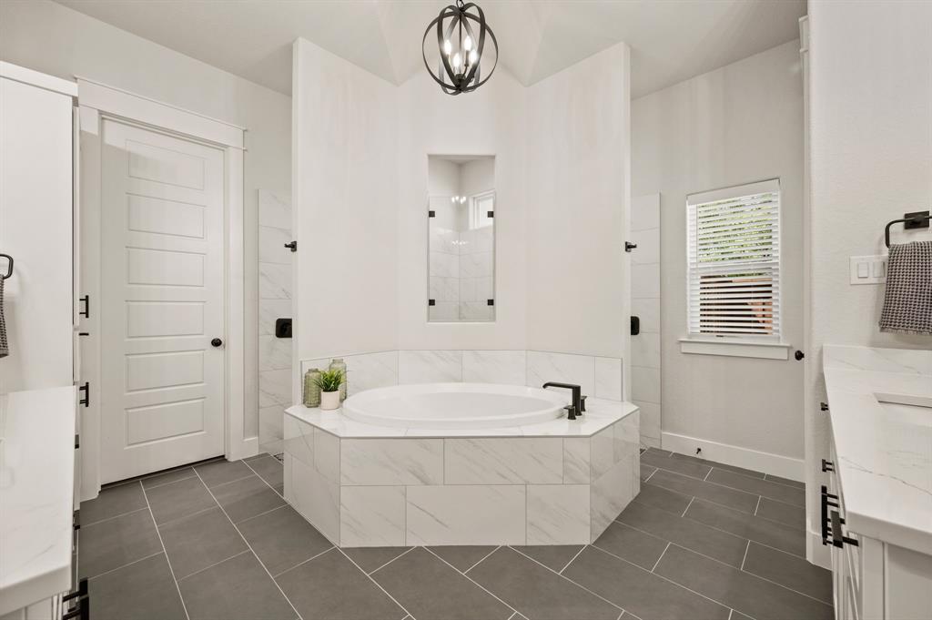 200 Clayton Crossing Springtown, TX 76082 - Photo 16 of 40 a bathroom with bathtub shower and mirror