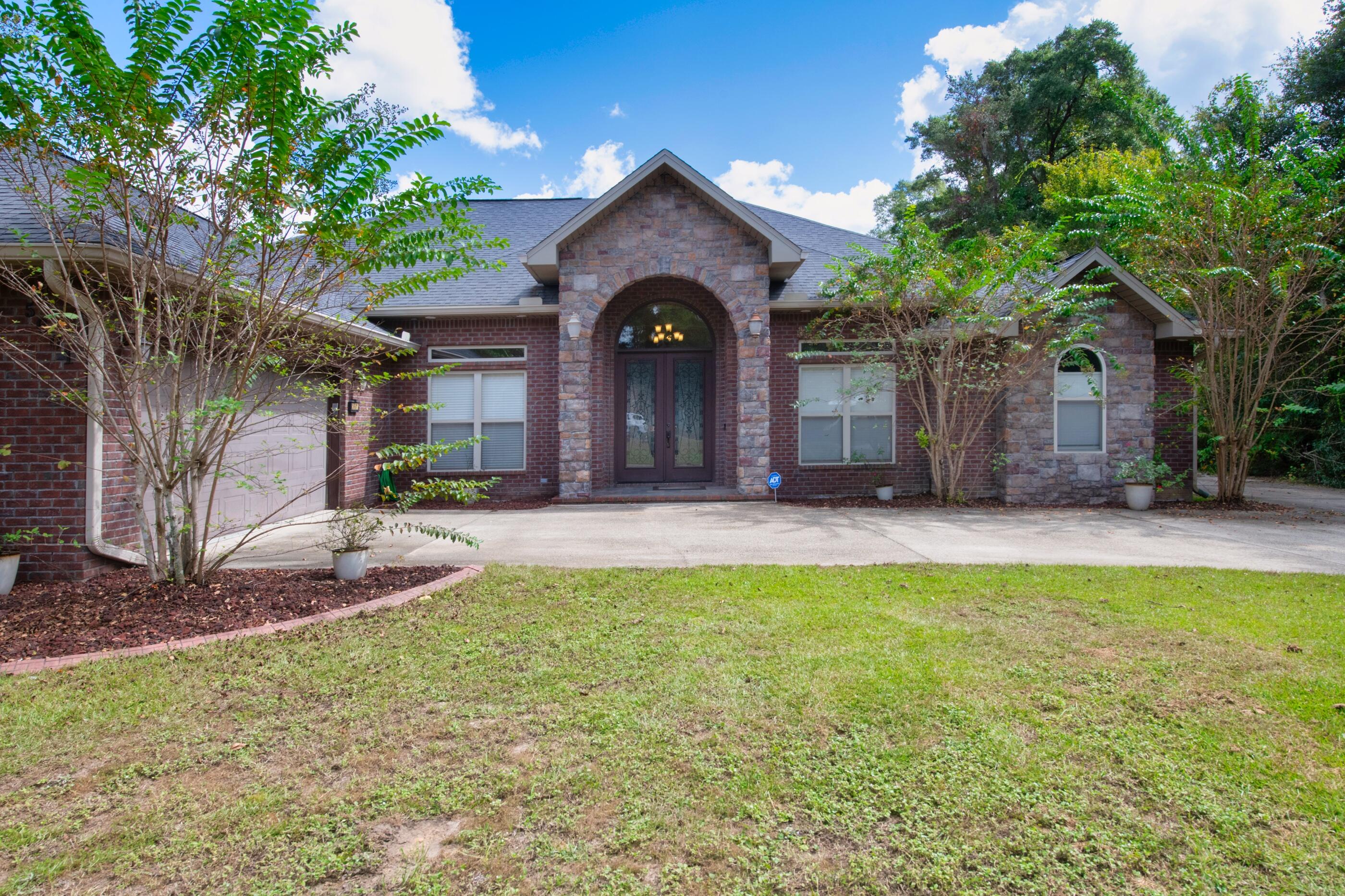 5601 Old River Road Baker, FL 32531 - Photo 1 of 45 a front view of a house with a yard