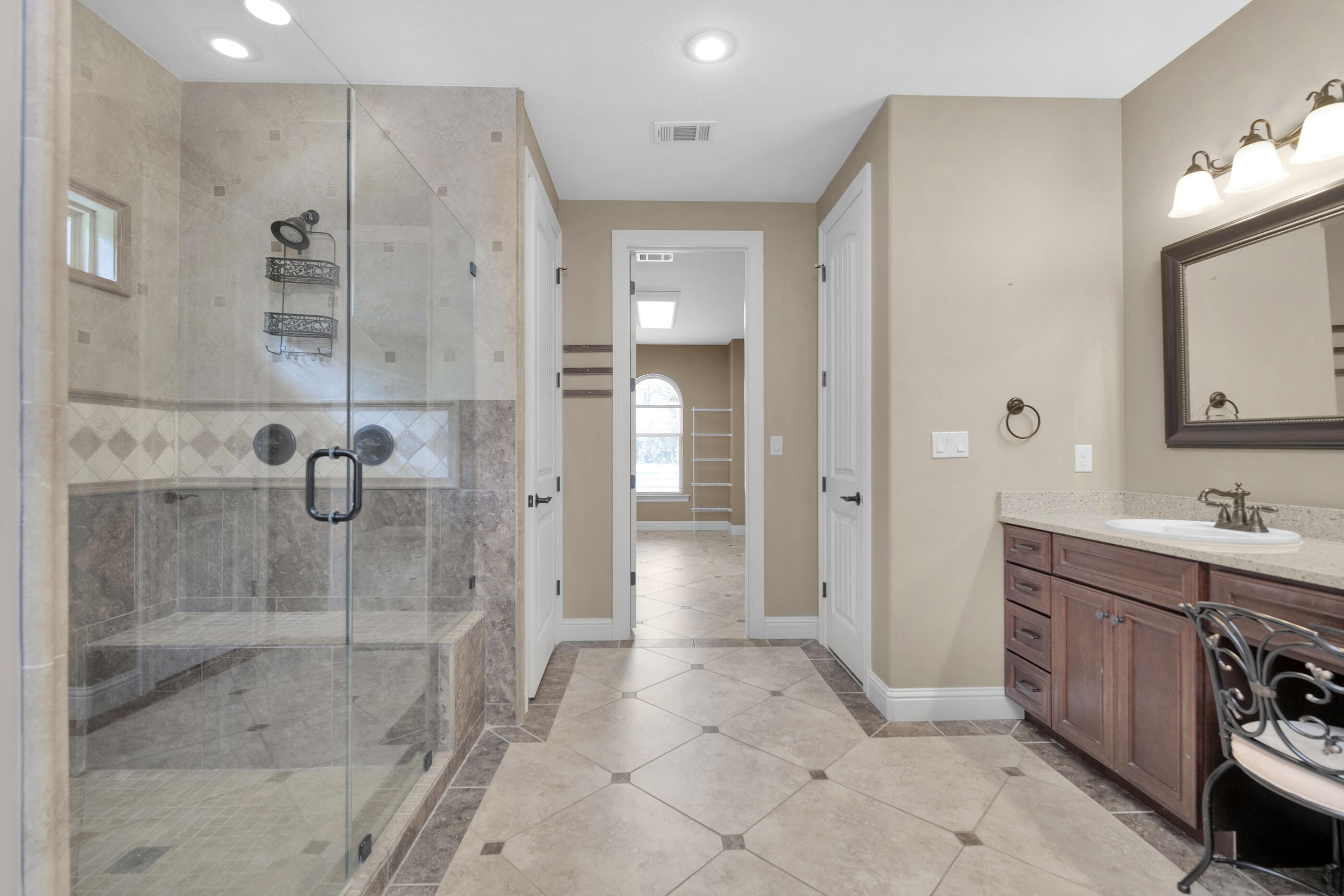 5601 Old River Road Baker, FL 32531 - Photo 18 of 45 a bathroom with a shower sink and mirror
