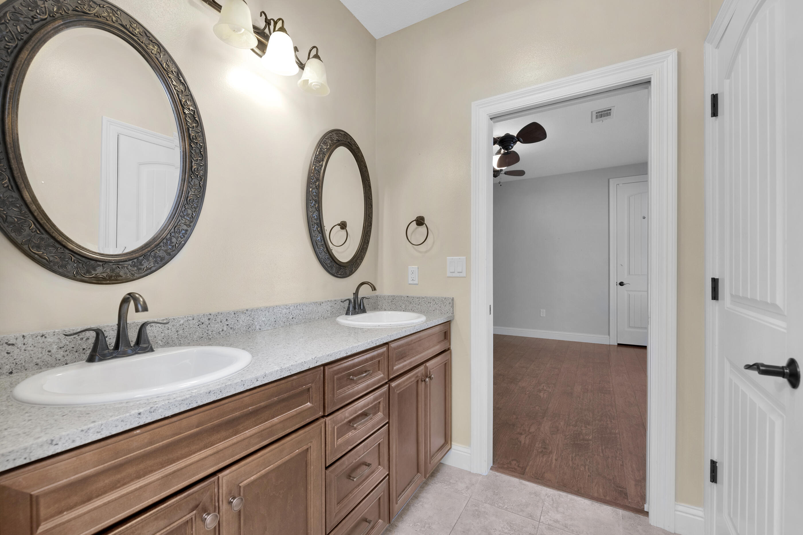 5601 Old River Road Baker, FL 32531 - Photo 28 of 45 a bathroom with a granite countertop sink and a mirror