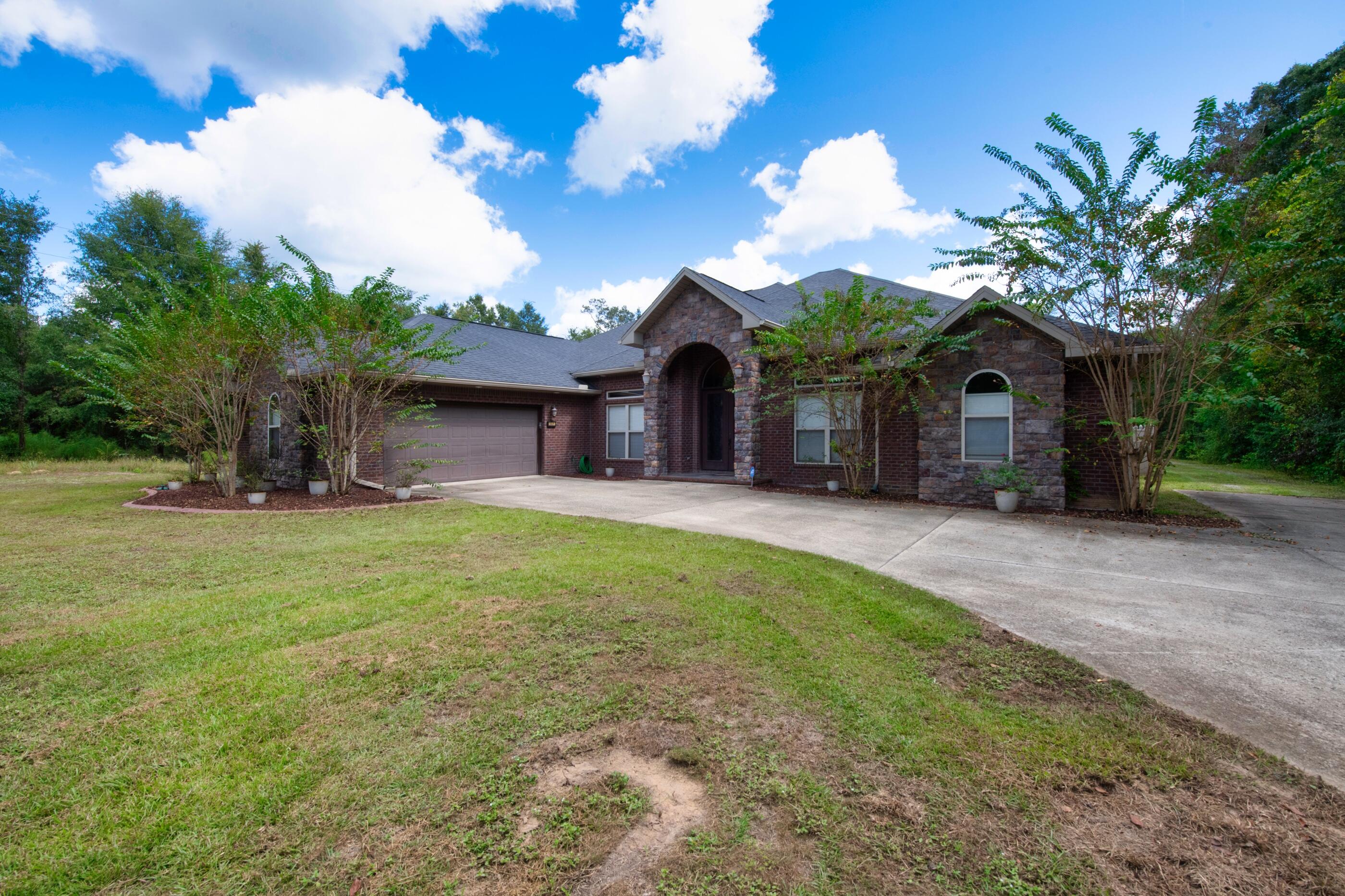 5601 Old River Road Baker, FL 32531 - Photo 3 of 45 a view of a house with a yard