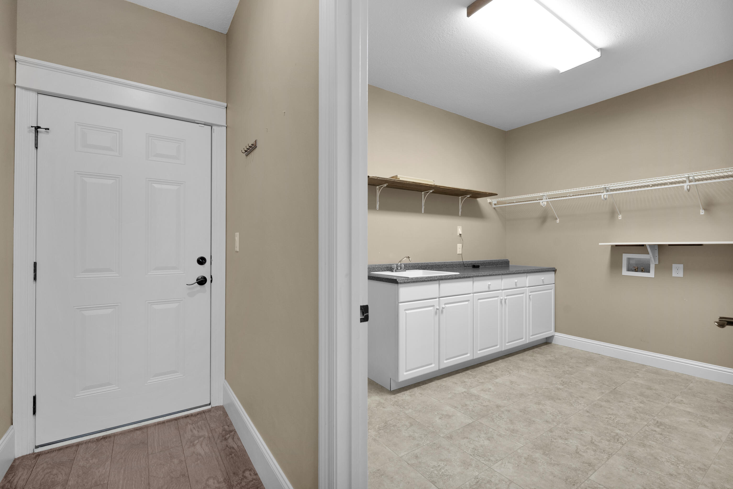5601 Old River Road Baker, FL 32531 - Photo 32 of 45 a kitchen with granite countertop white cabinets and white appliances