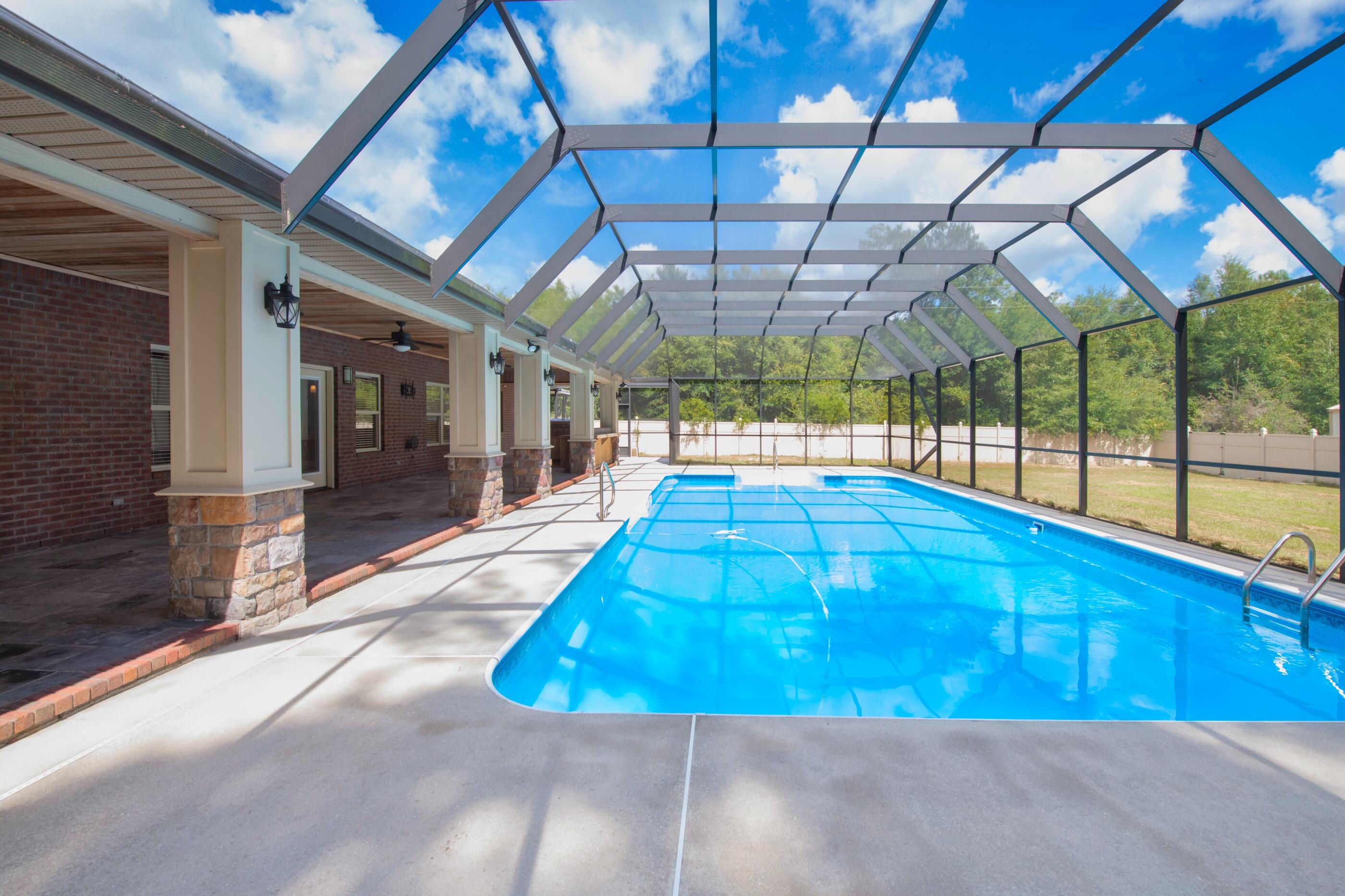 5601 Old River Road Baker, FL 32531 - Photo 37 of 45 a view of a swimming pool with a patio
