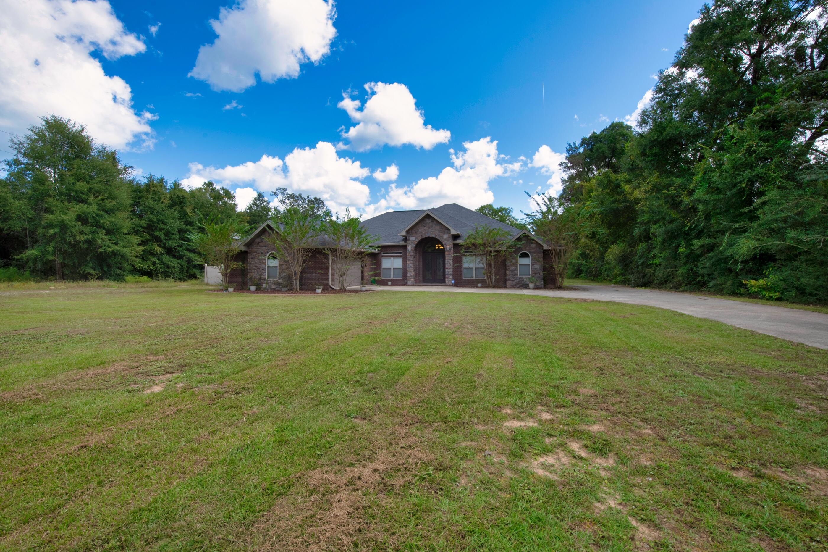5601 Old River Road Baker, FL 32531 - Photo 44 of 45 a view of a house with a big yard