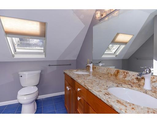 371 Sargent Road Boxborough, MA 01719 - Photo 18 of 30 a bathroom with a granite countertop toilet a sink and a mirror