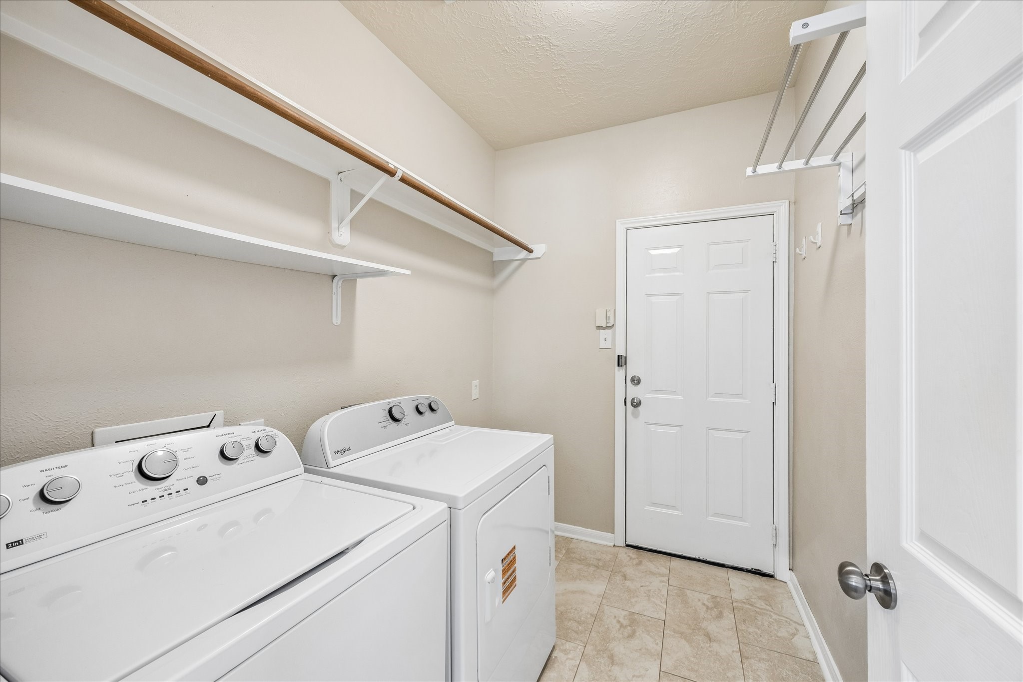 5811 Walkabout Way Katy, TX 77450 - Photo 25 of 33 Large utility room with additional storage and convenient access for everyday functionality.