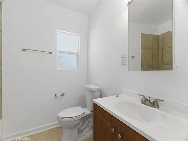 a bathroom with a sink toilet and mirror