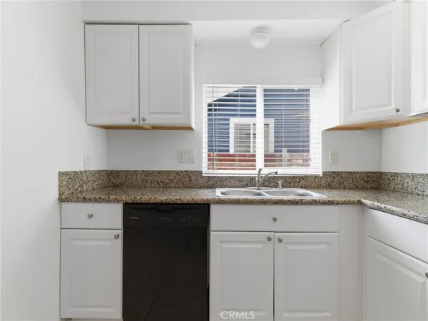 a kitchen with granite countertop white cabinets and a granite counter tops