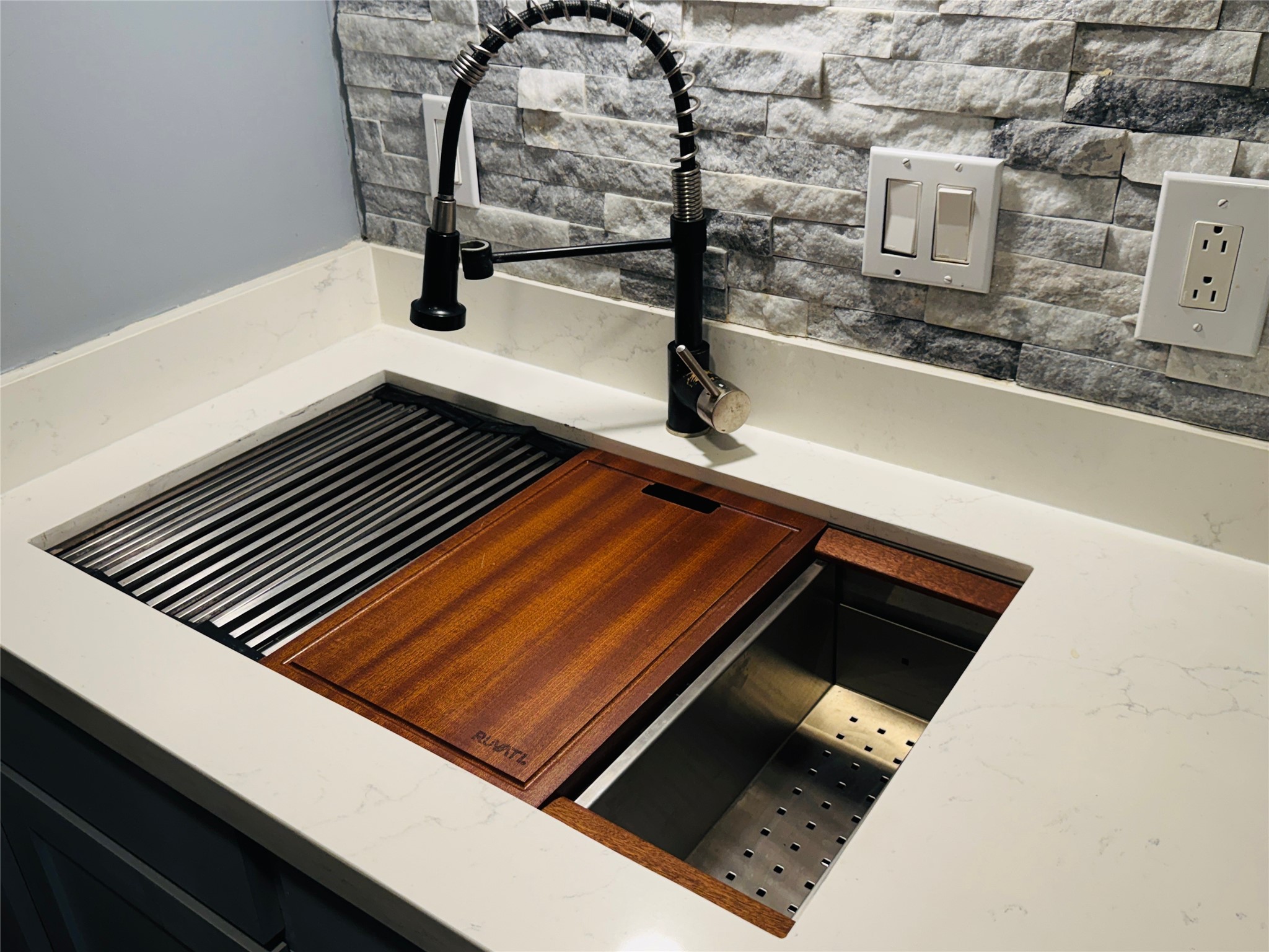 5800 Lumberdale Road, Unit 90 Houston, TX 77092 - Photo 20 of 39 The oversized kitchen sink offers a removealble draining mat, cutting board and colander.