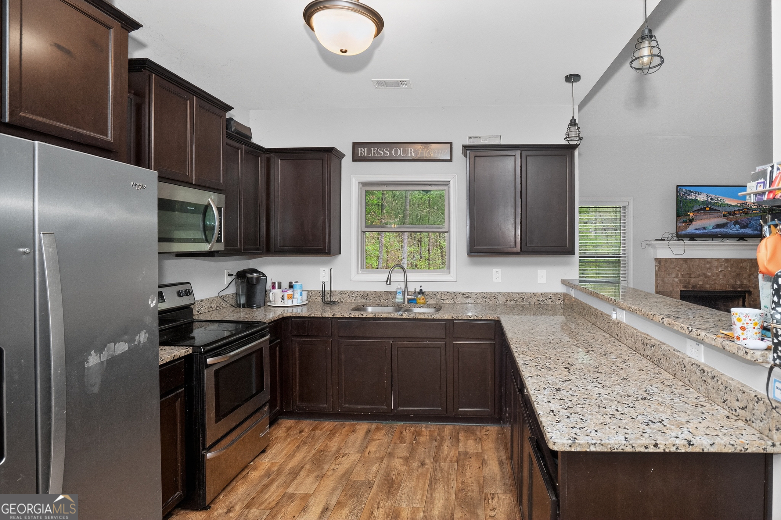 39 Crow Court Monticello, GA 31064 - Photo 18 of 39 a kitchen with stainless steel appliances granite countertop a sink stove and refrigerator
