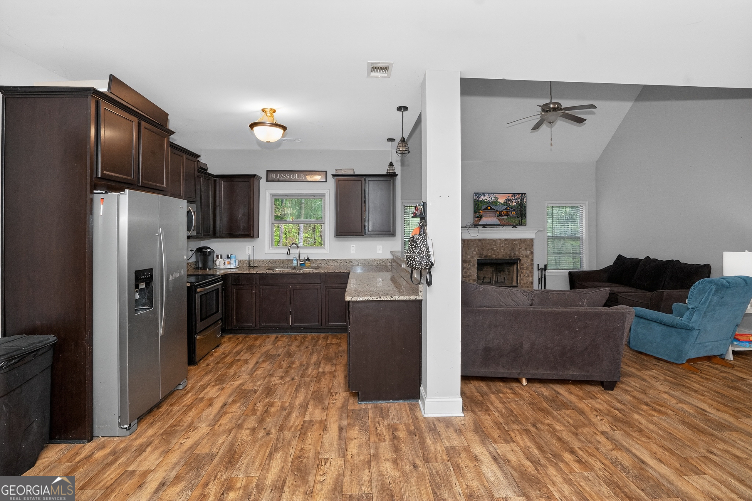 39 Crow Court Monticello, GA 31064 - Photo 21 of 39 a kitchen with a refrigerator cabinets and wooden floor