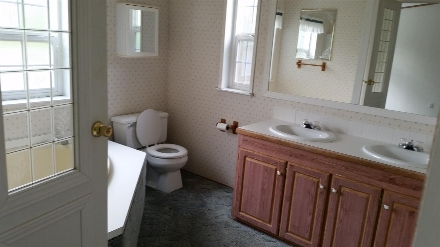 511 Donet Lane Merlin, OR 97532 - Photo 12 of 29 a bathroom with a granite countertop sink a toilet and a window
