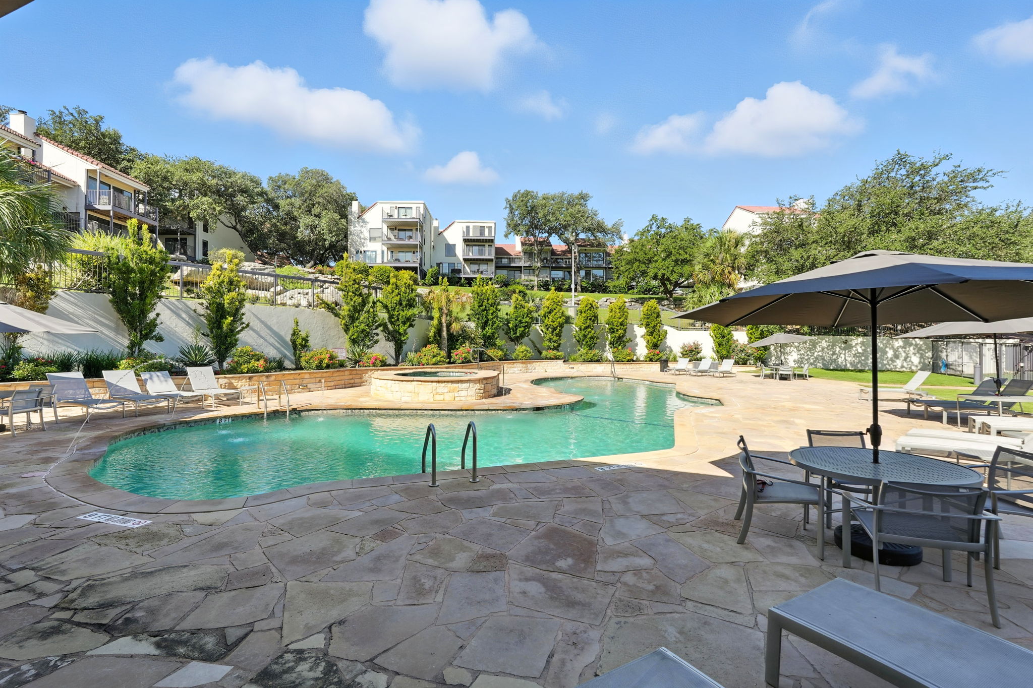 2918 Ranch Road 620 North, Unit C115 Austin, TX 78734 - Photo 31 of 39 Swimming pool featuring a patio and an in-ground hot tub