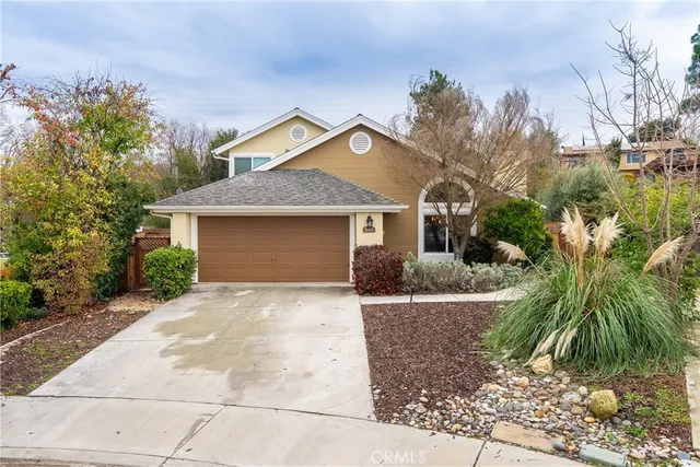 a front view of house with yard and trees around