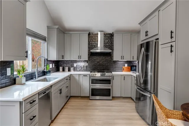 a kitchen with a refrigerator stove top oven and sink