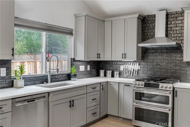 a kitchen with appliances a sink and cabinets