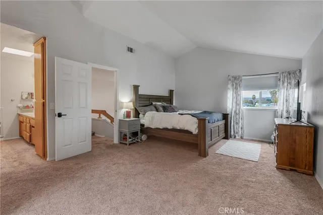 a bed room with a bed and a chair