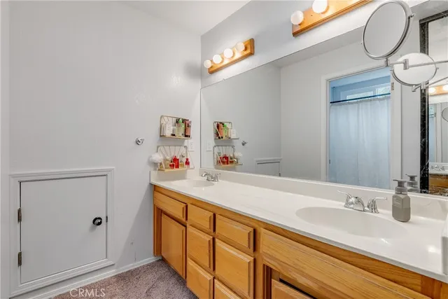 a bathroom with a sink a vanity and a mirror