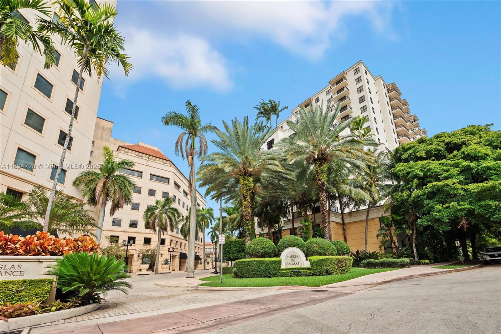 888 Douglas Road, Unit 113 Coral Gables, FL 33134 - Photo 2 of 40 a view of a palm trees in front of a building