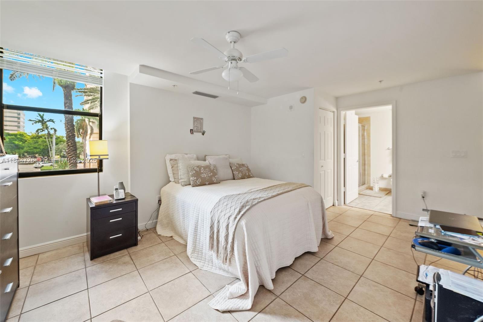 888 Douglas Road, Unit 113 Coral Gables, FL 33134 - Photo 26 of 40 a bedroom with a bed and a window