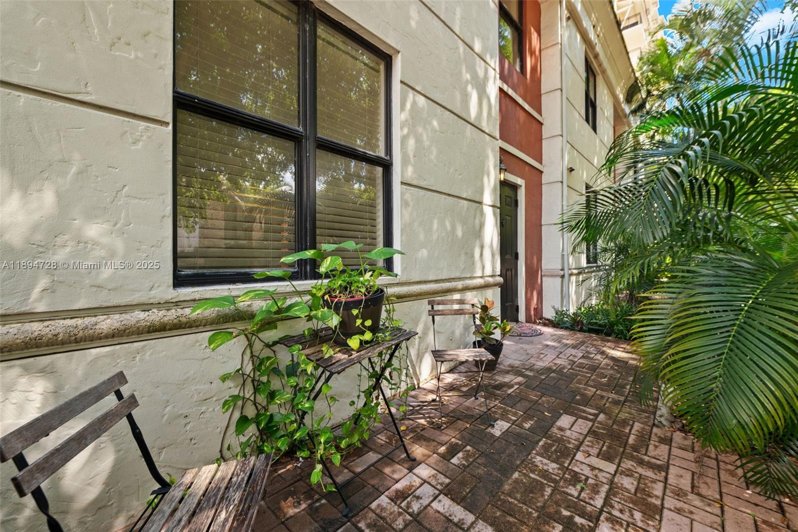 888 Douglas Road, Unit 113 Coral Gables, FL 33134 - Photo 31 of 40 a couple of flower plants in front of a building