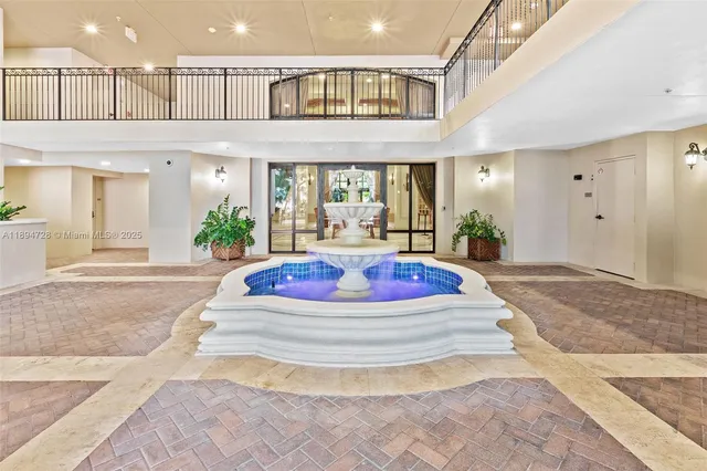 a living room with a large window and chandelier