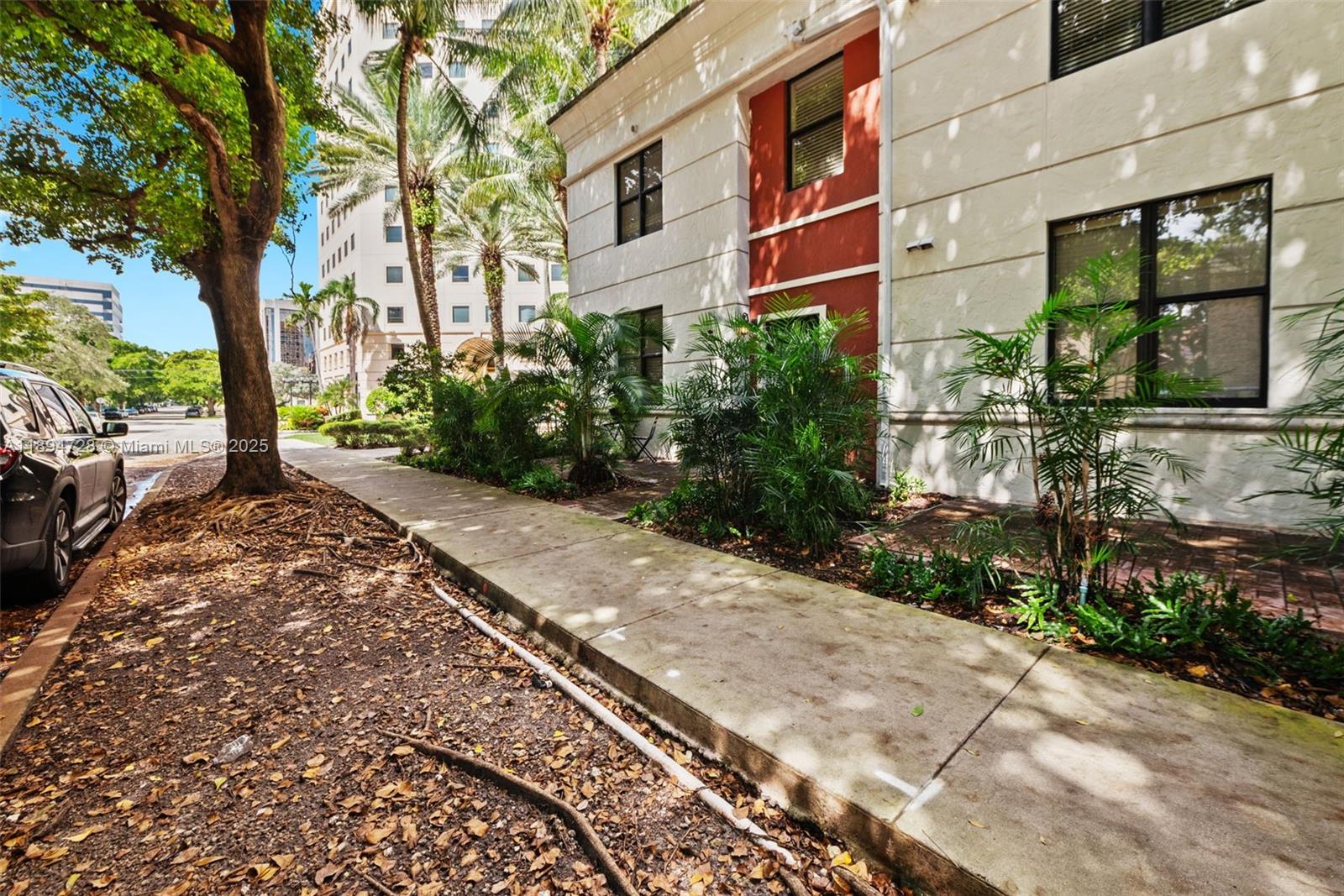 888 Douglas Road, Unit 113 Coral Gables, FL 33134 - Photo 7 of 40 a view of a pathway with a garden