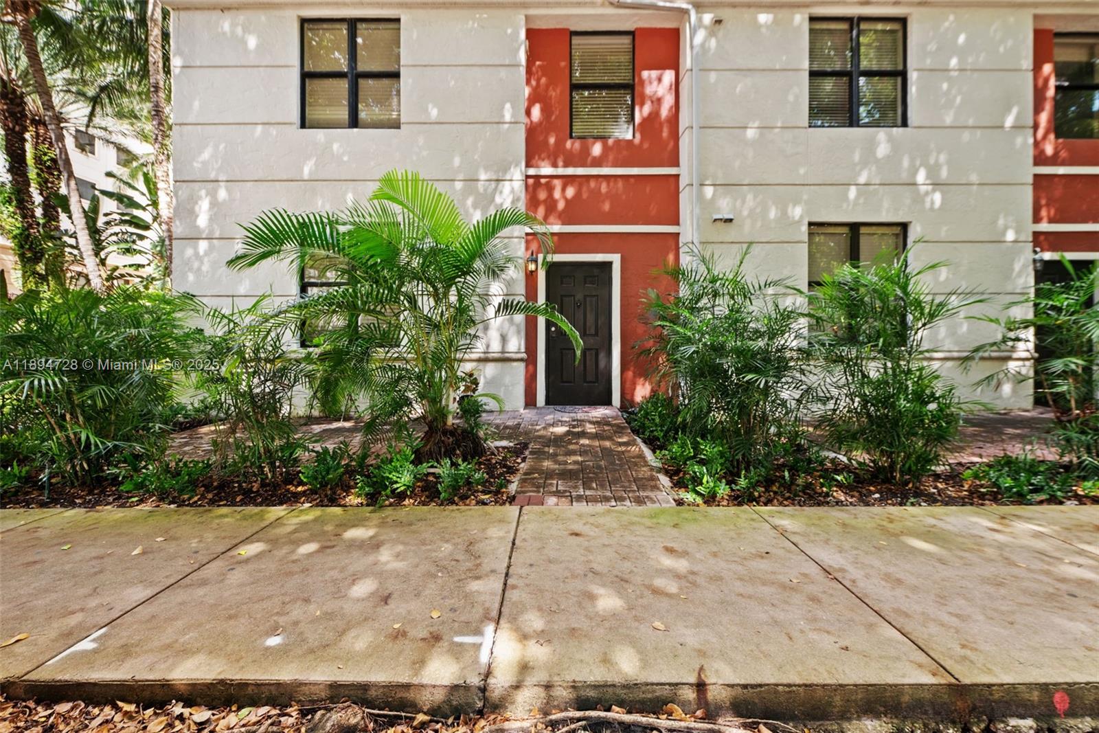 888 Douglas Road, Unit 113 Coral Gables, FL 33134 - Photo 8 of 40 a front view of a multi story residential apartment building
