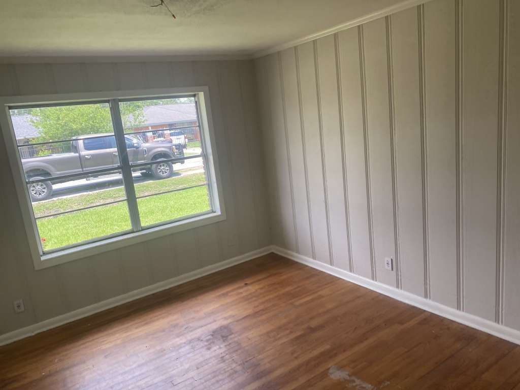 205 West Rittenhouse Street Houston, TX 77076 - Photo 3 of 17 a view of an empty room with wooden floor and a window
