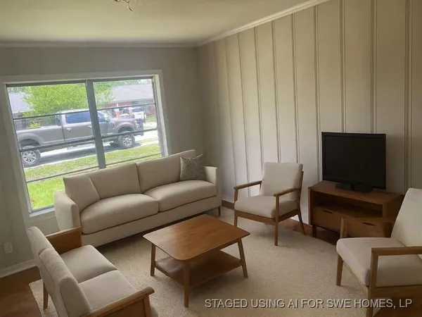 a living room with furniture a rug and a window