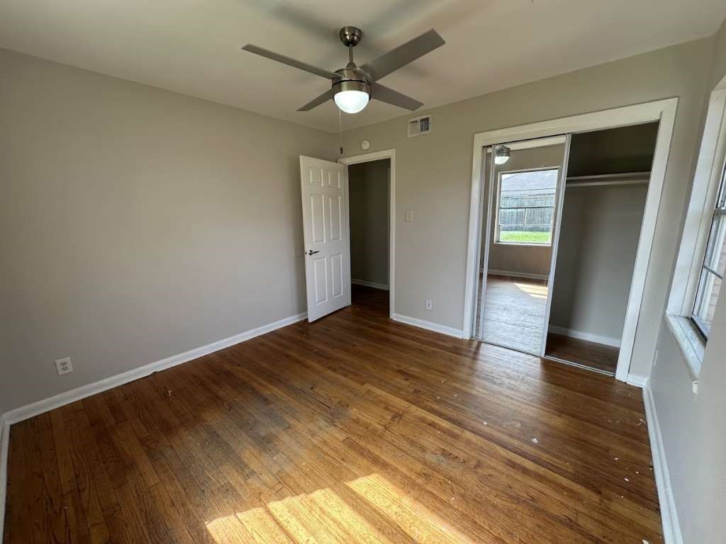 205 West Rittenhouse Street Houston, TX 77076 - Photo 7 of 17 wooden floor in an empty room with a window