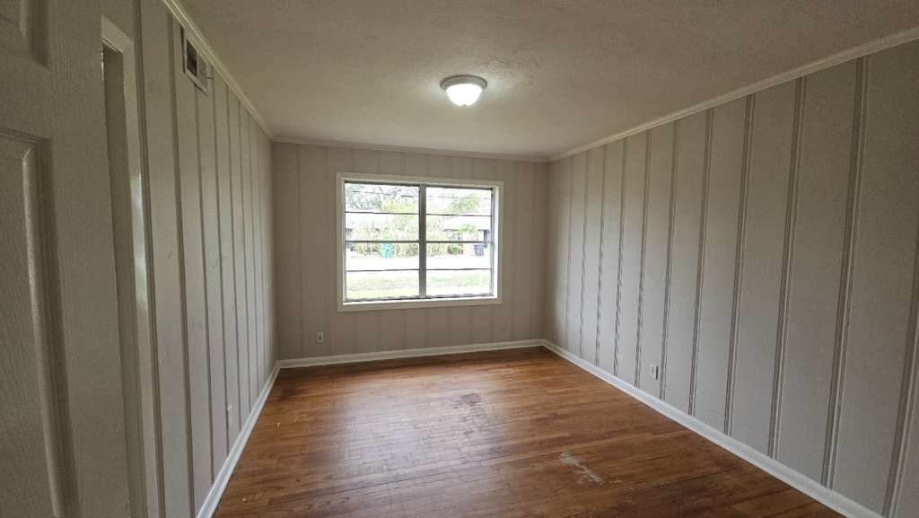 205 West Rittenhouse Street Houston, TX 77076 - Photo 9 of 17 a view of an empty room with wooden floor and a window