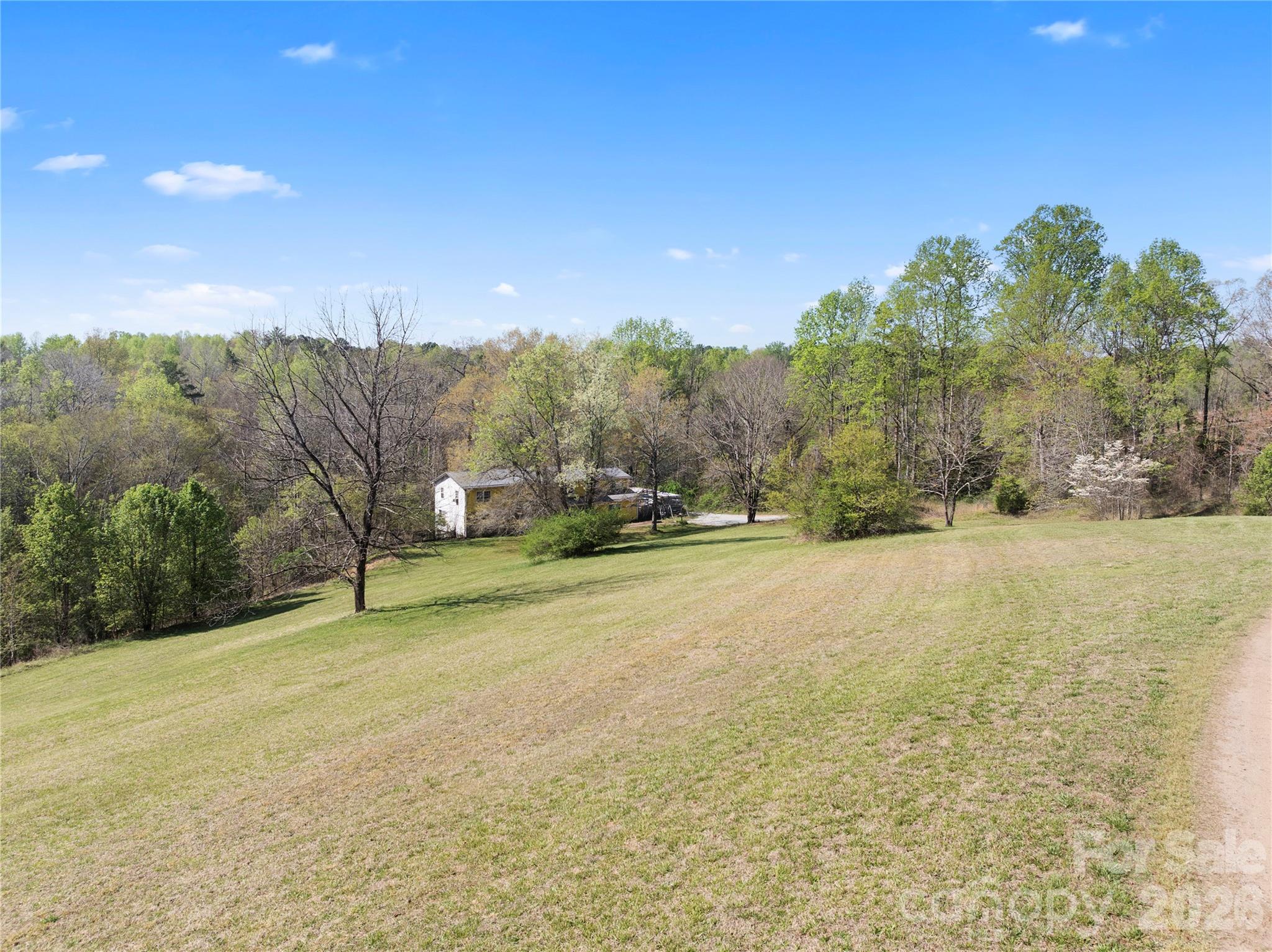 4675 Hickory Nut Ridge Road Granite Falls, NC 28630 - Photo 3 of 14 a view of a field with trees in the background