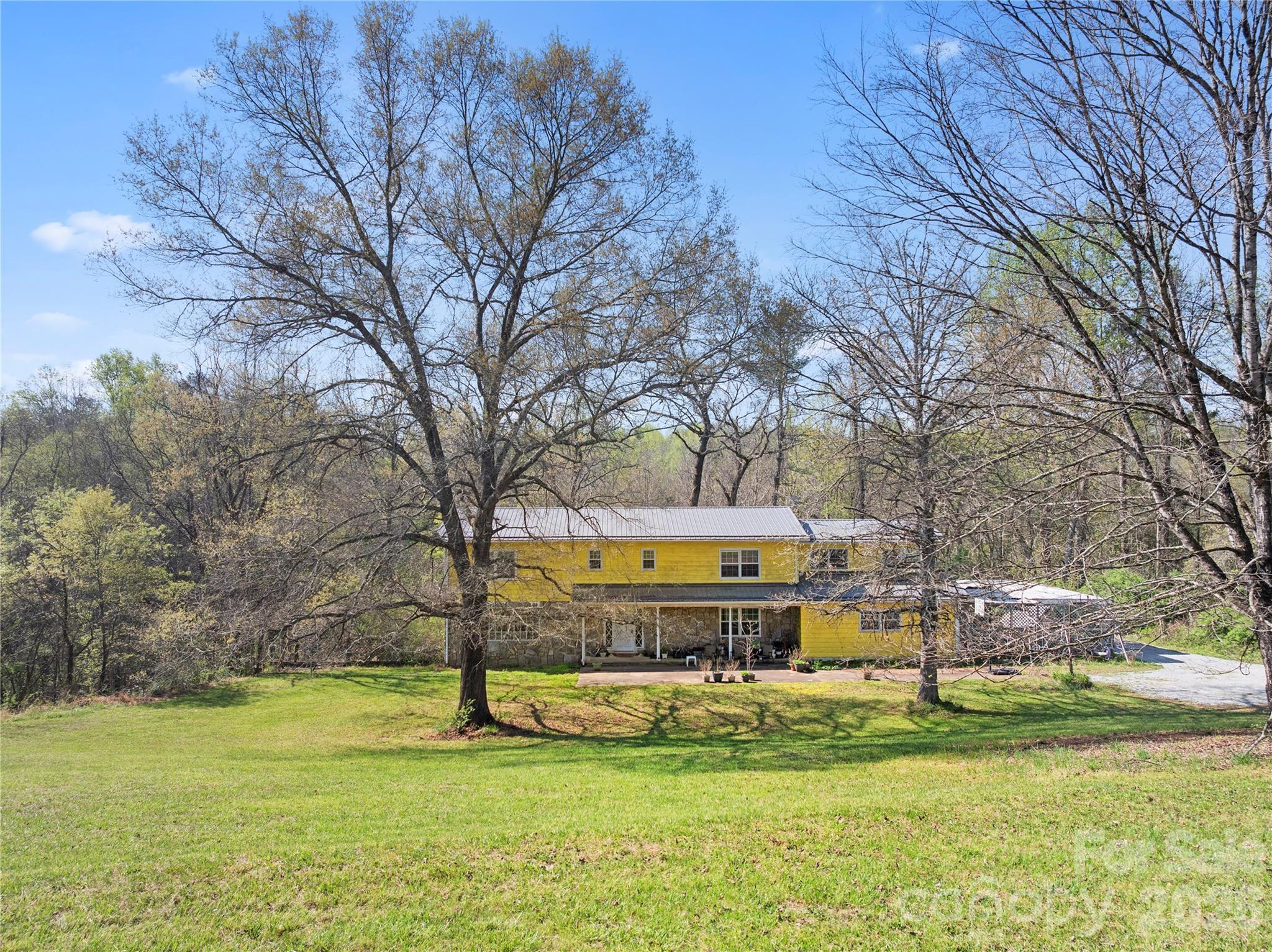 4675 Hickory Nut Ridge Road Granite Falls, NC 28630 - Photo 6 of 14 a view of a swimming pool with big yard and large trees