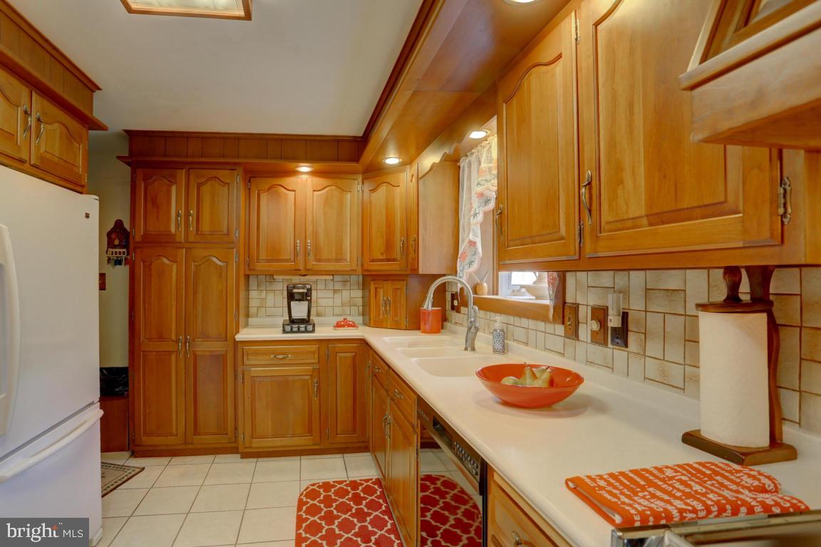 106 Brubaker Road Lititz, PA 17543 - Photo 10 of 25 a kitchen with sink a refrigerator and chairs