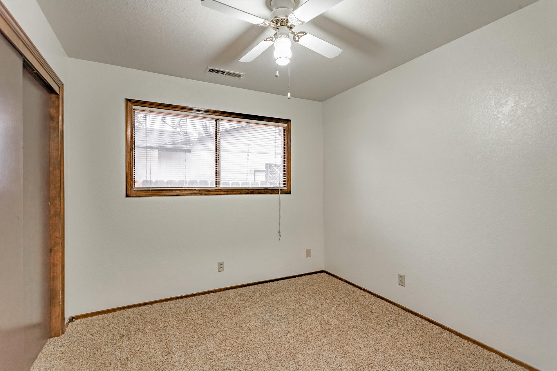 3612 Echo Road Redding, CA 96002 - Photo 8 of 10 an empty room with a window and a ceiling fan