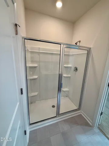 a bathroom with a glass door shower