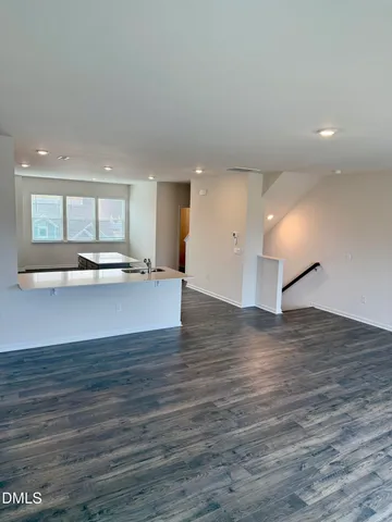 a view of a kitchen with a sink and a large window