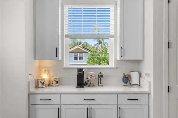 a kitchen with a sink window and cabinets