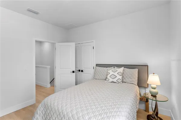 a bedroom with a bed and a lamp